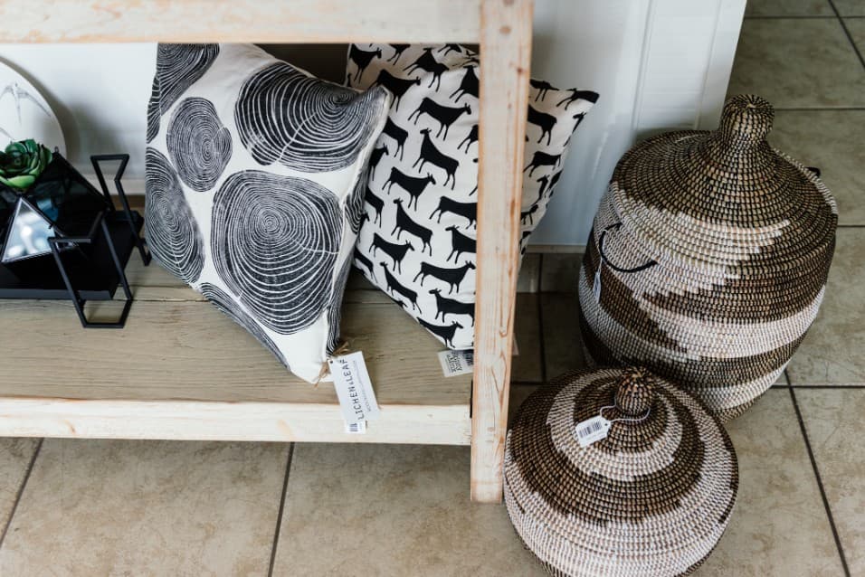 Patterned cushions and woven baskets on display