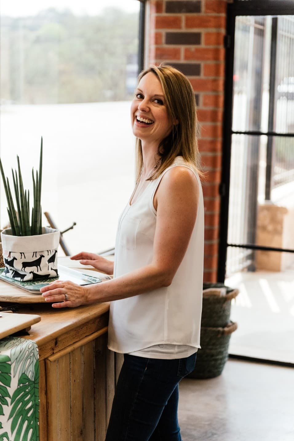 Smiling woman behind a shop counter