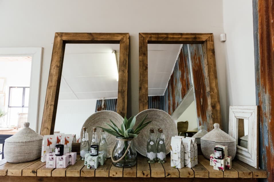 Wooden mirrors, ceramics and gifts on a long shelf