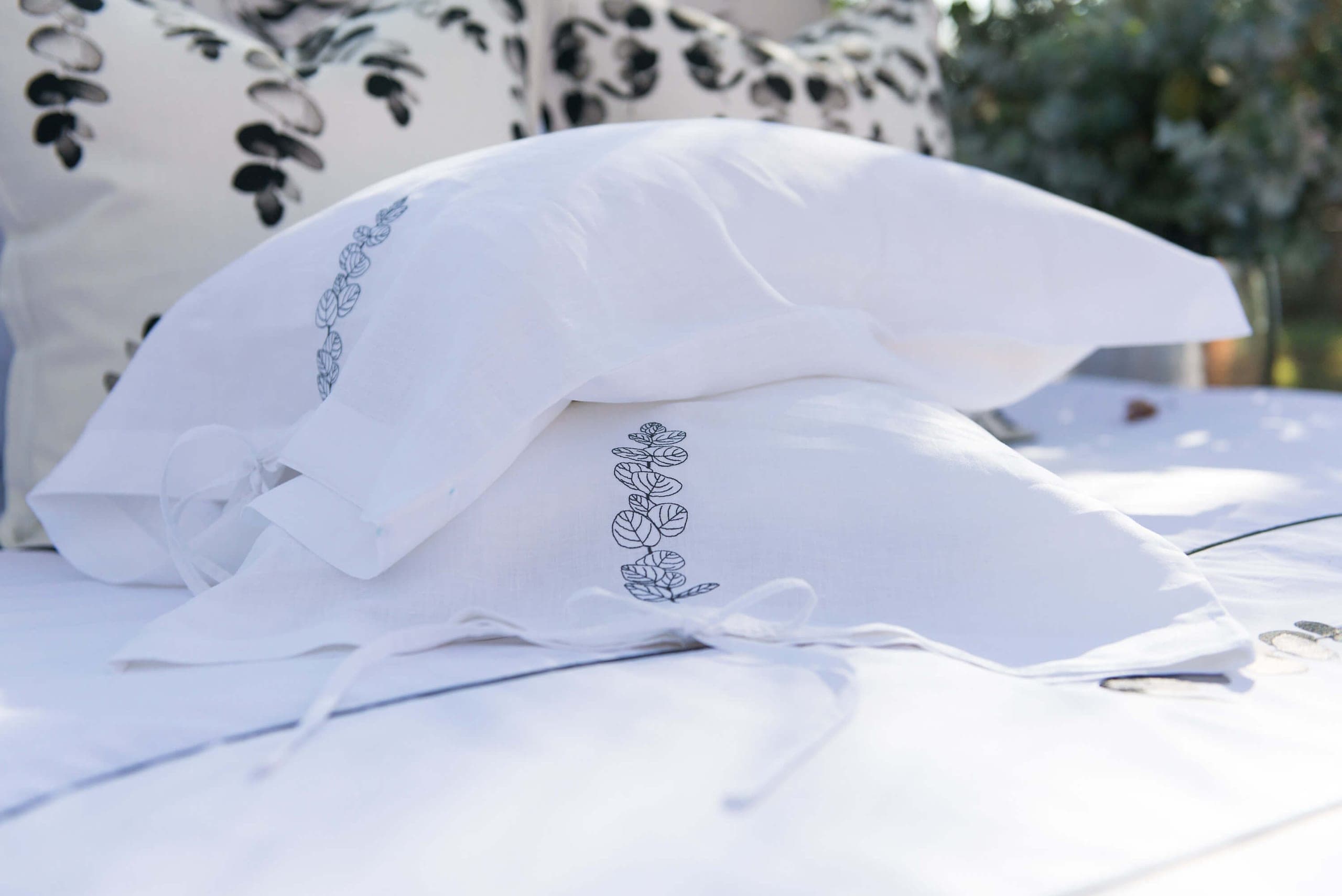 White pillowcases embroidered with a leaf design