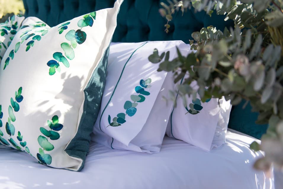 Close-up of cushions and pillowcases printed with eucalyptus leaves