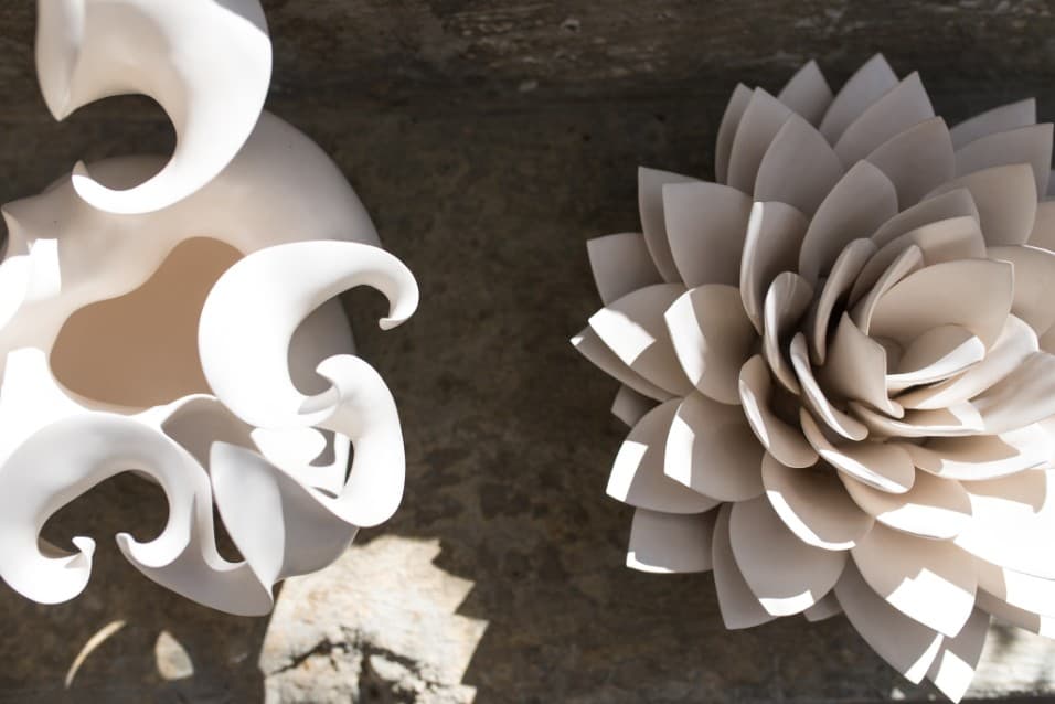 White ceramic flower and wave sculptures