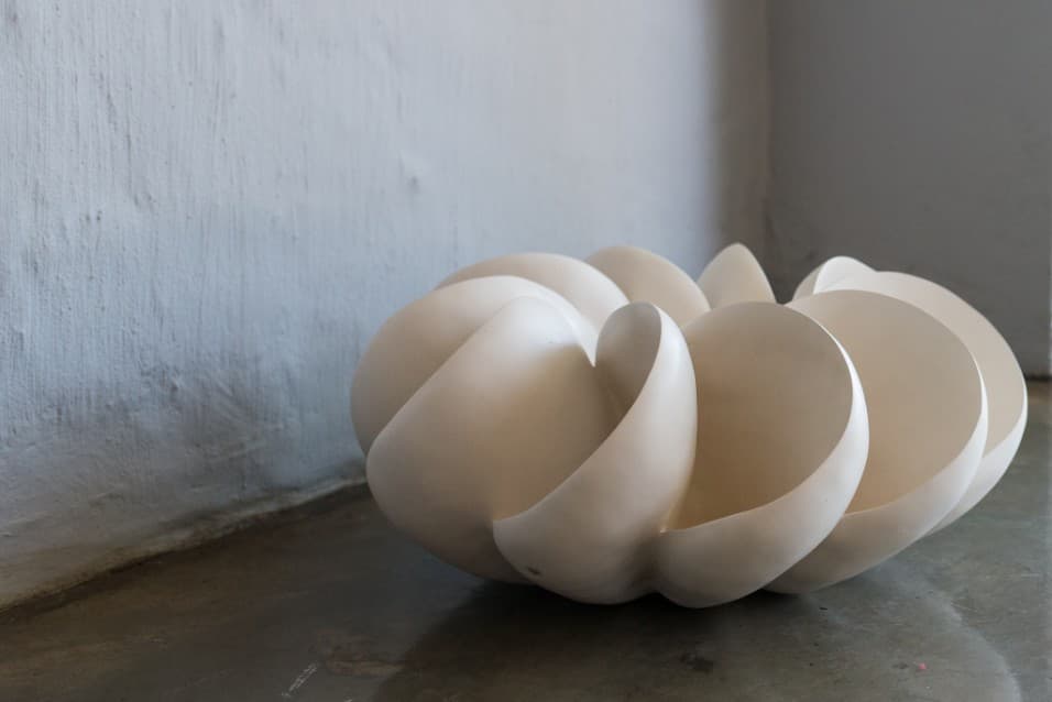 White ceramic sculpture of curved petals