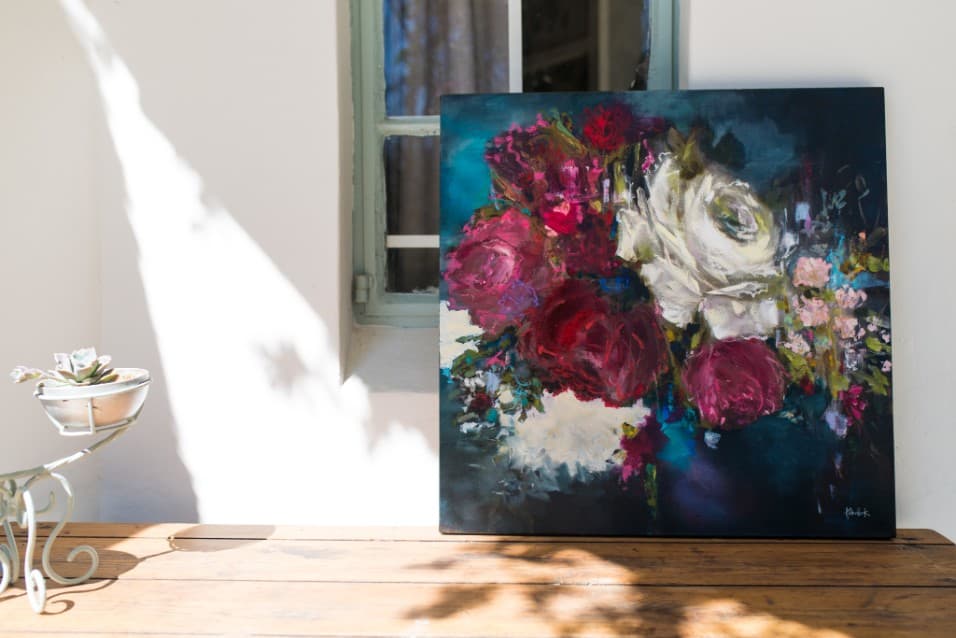 Painting of dark red and white roses on a veranda