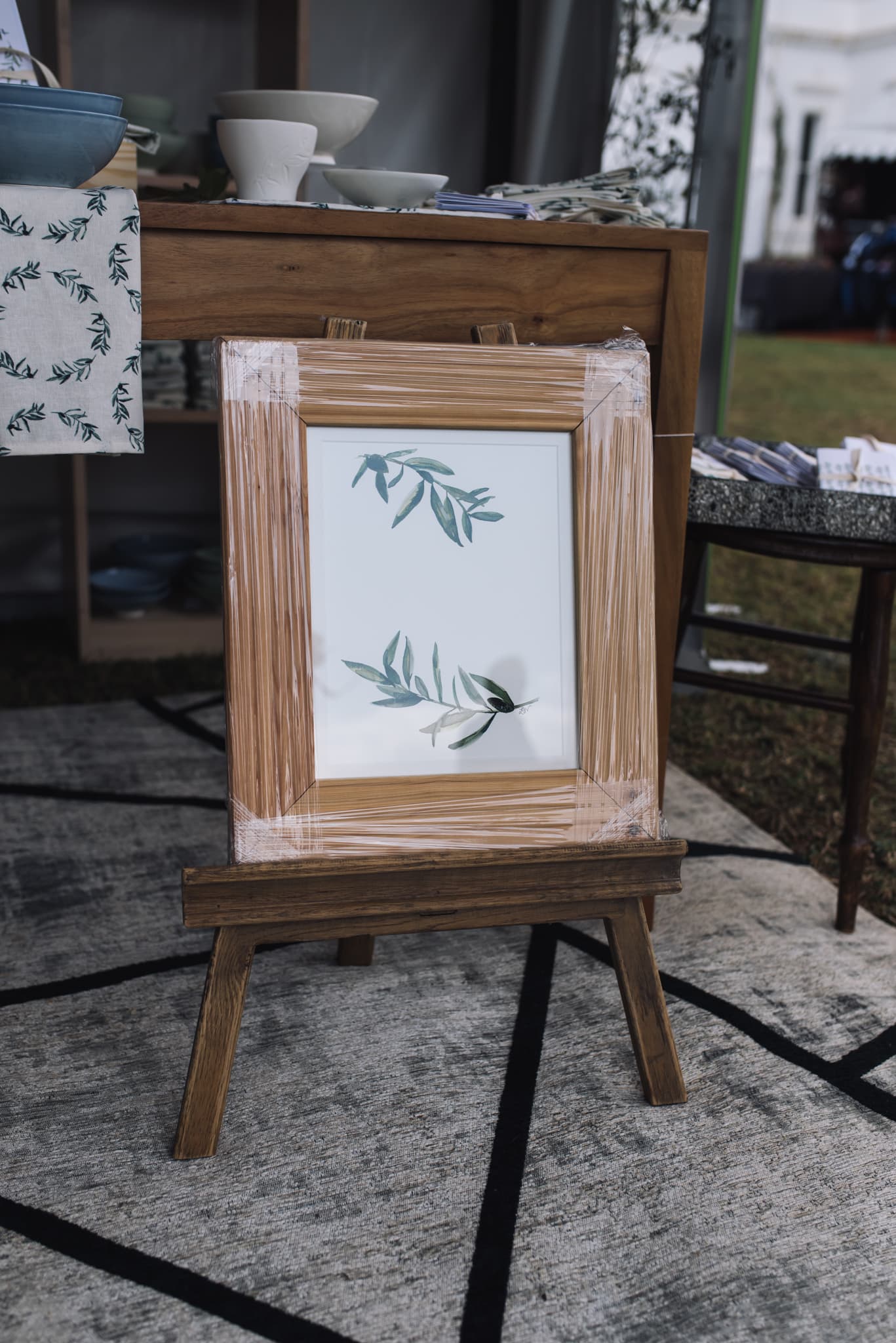 Framed olive-branch watercolour on a small easel