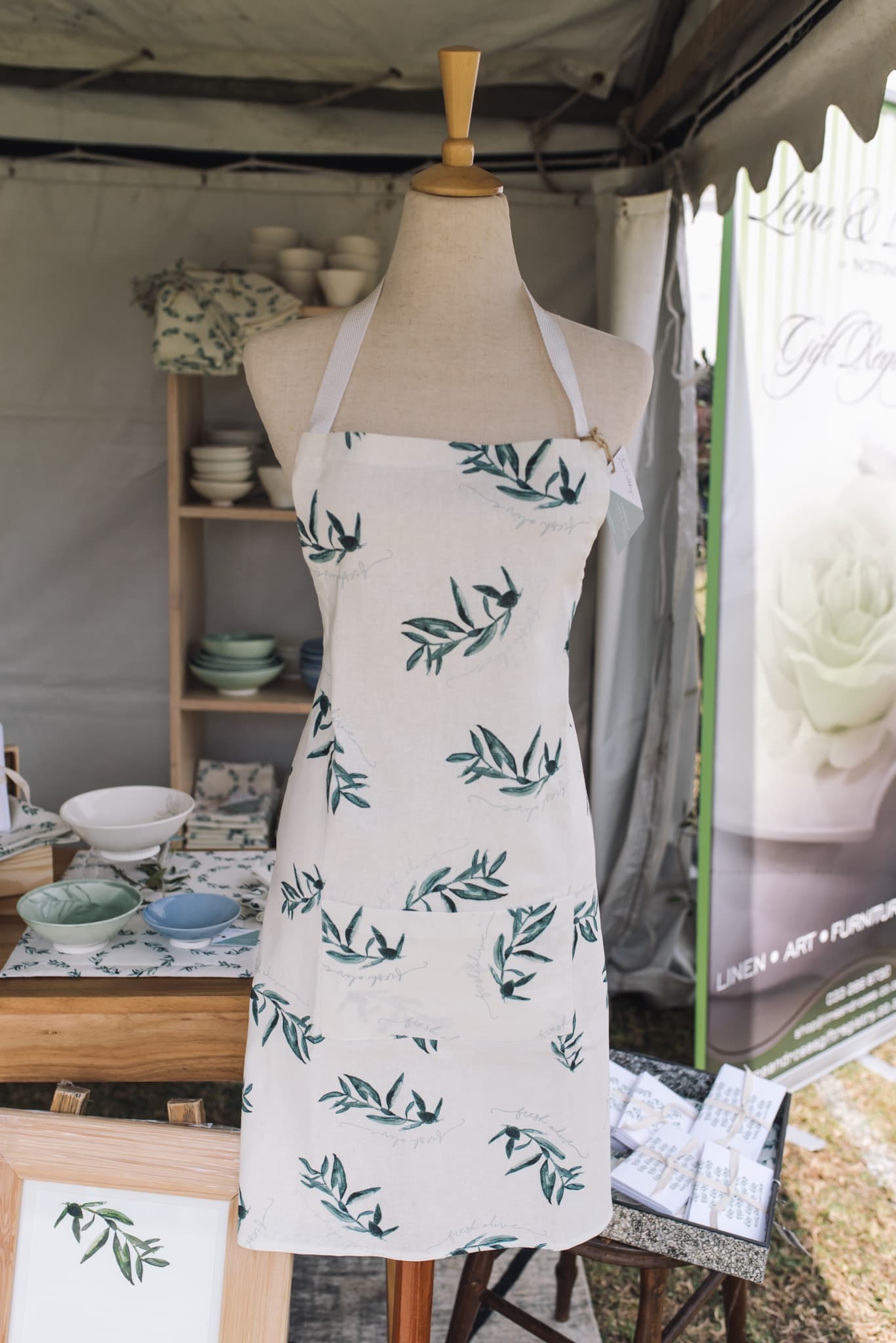 Olive-print apron on a dress form